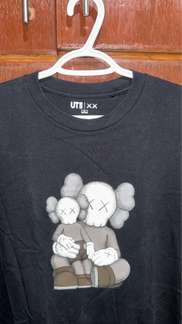 Uniqlo UT x KAWS Black Graphic Tee (Category: Shirts) located in General Trias. Submitted by jameswlopez (Listing ID 1467982120, Image 2). Description: Selling my Black graphic t-shirt from the Uniqlo UT and KAWS collaboration. -Size: Small -Good as new 📦 Shipping: Available via J&T or LBC. Shipping fee to be shouldered by the buyer..