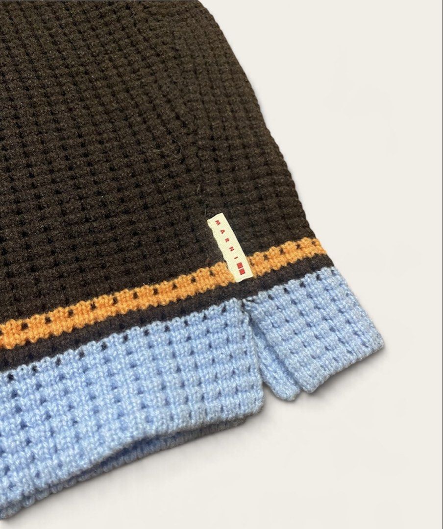 UNIQLO x MARNI Popcorn Knitted Balaclava (Category: Beanies) located in Naga. Submitted by dailyshipped (Listing ID 1468031380, Image 3). Description: • Material & Texture: Crafted with a textured waffle/popcorn knit stitch that provides excellent insulation and stretch. • Design Features: It features a rich dark brown base contrasted by sharp orange and sky-blue horizontal striped bands along the hem. A signature tiny woven Marni tag is attached