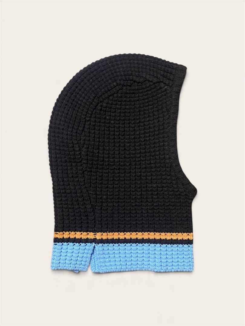 UNIQLO x MARNI Popcorn Knitted Balaclava (Category: Beanies) located in Naga. Submitted by dailyshipped (Listing ID 1468031380, Image 2). Description: • Material & Texture: Crafted with a textured waffle/popcorn knit stitch that provides excellent insulation and stretch. • Design Features: It features a rich dark brown base contrasted by sharp orange and sky-blue horizontal striped bands along the hem. A signature tiny woven Marni tag is attached