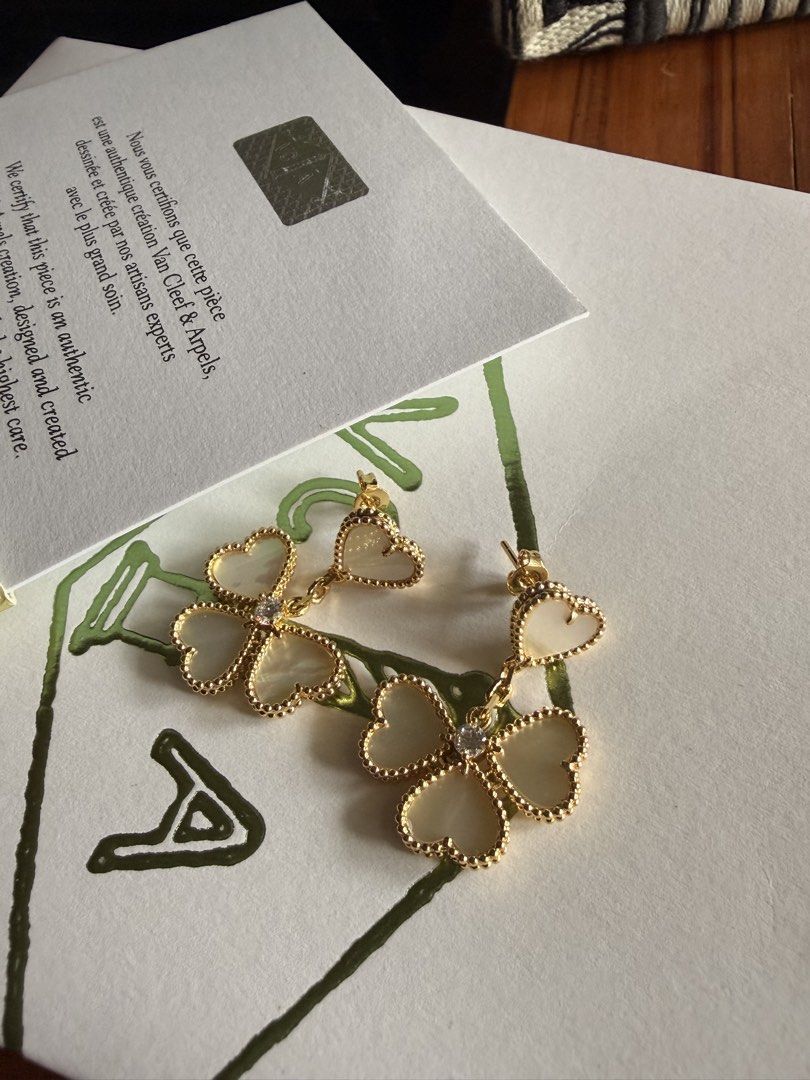 Van Cleef & Arpels Lucky Alhambra Earrings (Category: Earrings) located in Las Pinas. Submitted by twiceloved24 (Listing ID 1467891906, Image 2). Description: - Brand: Van Cleef & Arpels - Model: Lucky Alhambra Heart-Shaped Dangling Earrings - Authenticity: Includes certificate card and branded packaging envelope - Details: Clearly visible stamped hardware on the post - Condition: Great statement jewelry piece, well-maintained.