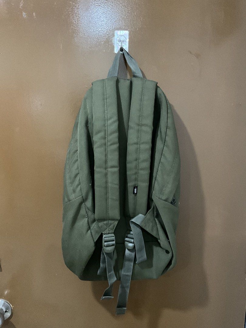 Vans Green Backpack (Category: Backpacks) located in Cagayan de Oro. Submitted by jojiiijoc68999 (Listing ID 1467887918, Image 2). Description: - Brand: Vans - Color: Army green - Material: Durable canvas - Features: Classic shape, front zip pocket, diamond patch detail, subtle checkerboard inner lining - Comfort: Adjustable shoulder straps with padded support and top haul loop - Condition: Clean overall, smooth-working zippers.