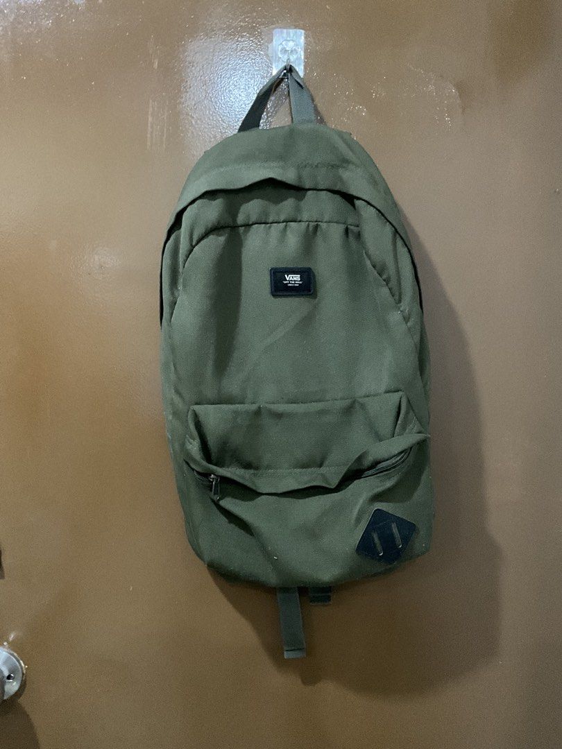 Vans Green Backpack (Category: Backpacks) located in Cagayan de Oro. Submitted by jojiiijoc68999 (Listing ID 1467887918, Image 1). Description: - Brand: Vans - Color: Army green - Material: Durable canvas - Features: Classic shape, front zip pocket, diamond patch detail, subtle checkerboard inner lining - Comfort: Adjustable shoulder straps with padded support and top haul loop - Condition: Clean overall, smooth-working zippers.