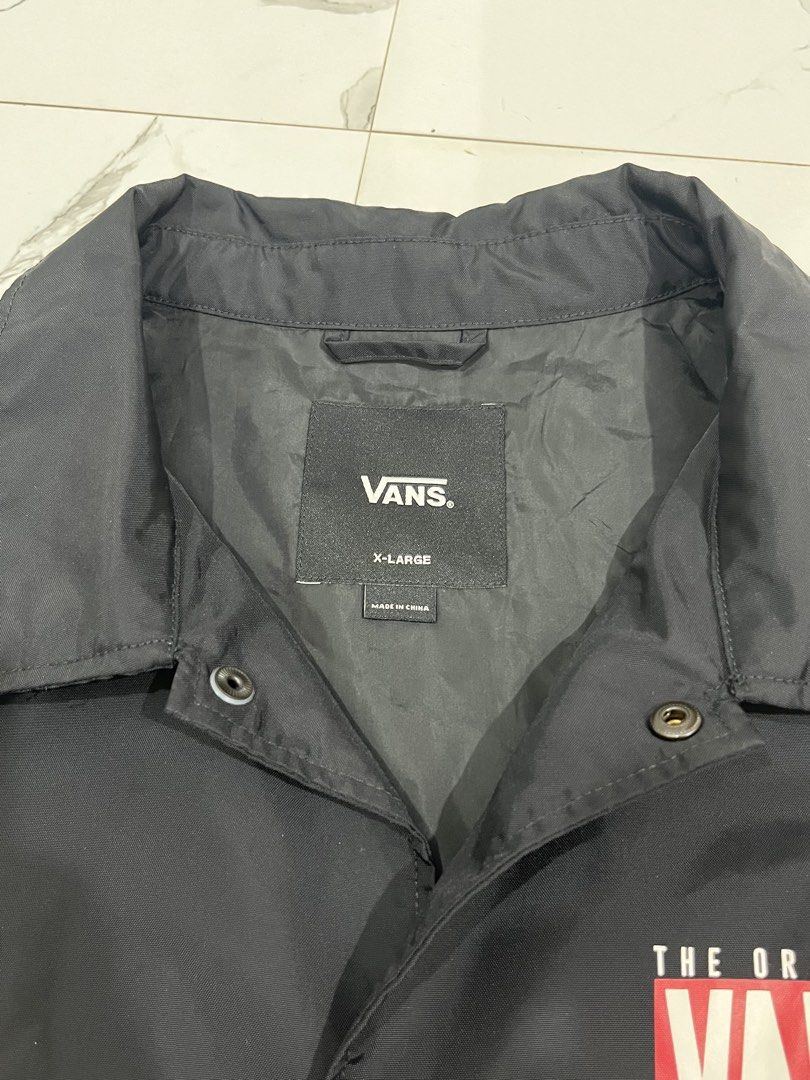 Vans Off The Wall Black Coach Jacket X-Large (Category: Coats, Jackets and Outerwear) located in Manila. Submitted by obedmagall74424 (Listing ID 1467874747, Image 3). Description: - Brand: Vans Off The Wall - Style: Black coach jacket - Size: Extra Large (XL) Dimensions 30.5x24 - Material: Lightweight nylon - Features: Snap button closure, collar neckline, two side pockets with small logo tags - Design: Small chest print and large graphic print 