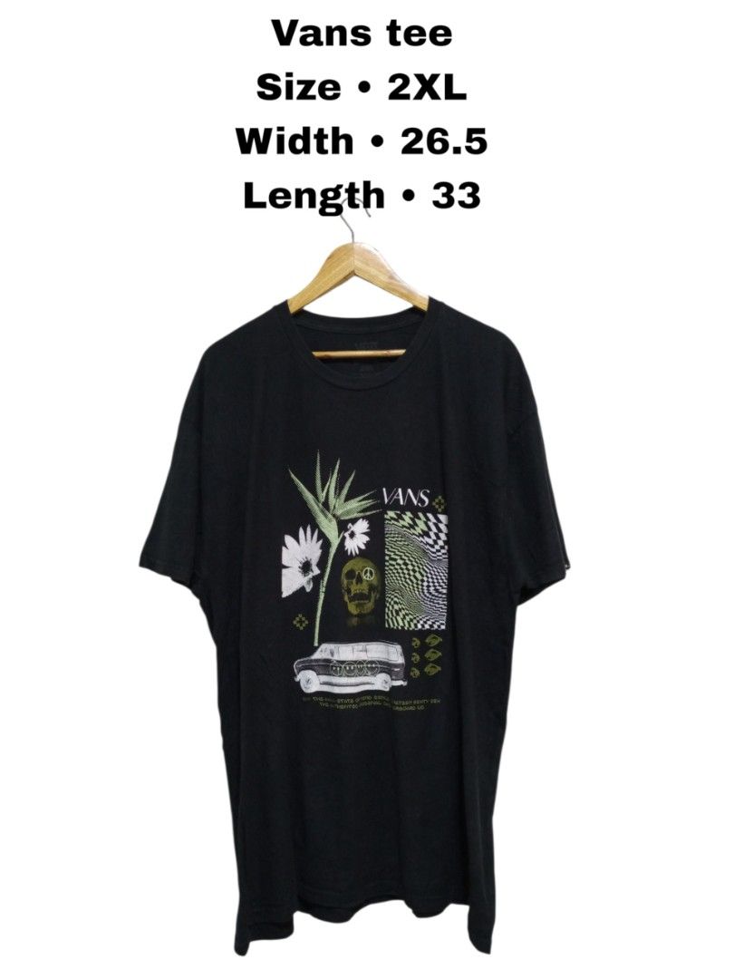 Vans Off the Wall Graphic Tee 2XL (Category: Tshirts & Polo Shirts ) located in Magdalena. Submitted by magdalenathrift20 (Listing ID 1467984613, Image 1). Description: - Brand: Vans - Style: Classic fit graphic t-shirt - Color: Black - Design: Bold front graphic with flowers, skull, and checkerboard pattern - Details: Small logo tag on left sleeve cuff - Material: 100% cotton - Size: XX-Large - Measurements (laid flat): Width 26.5 inches, Length