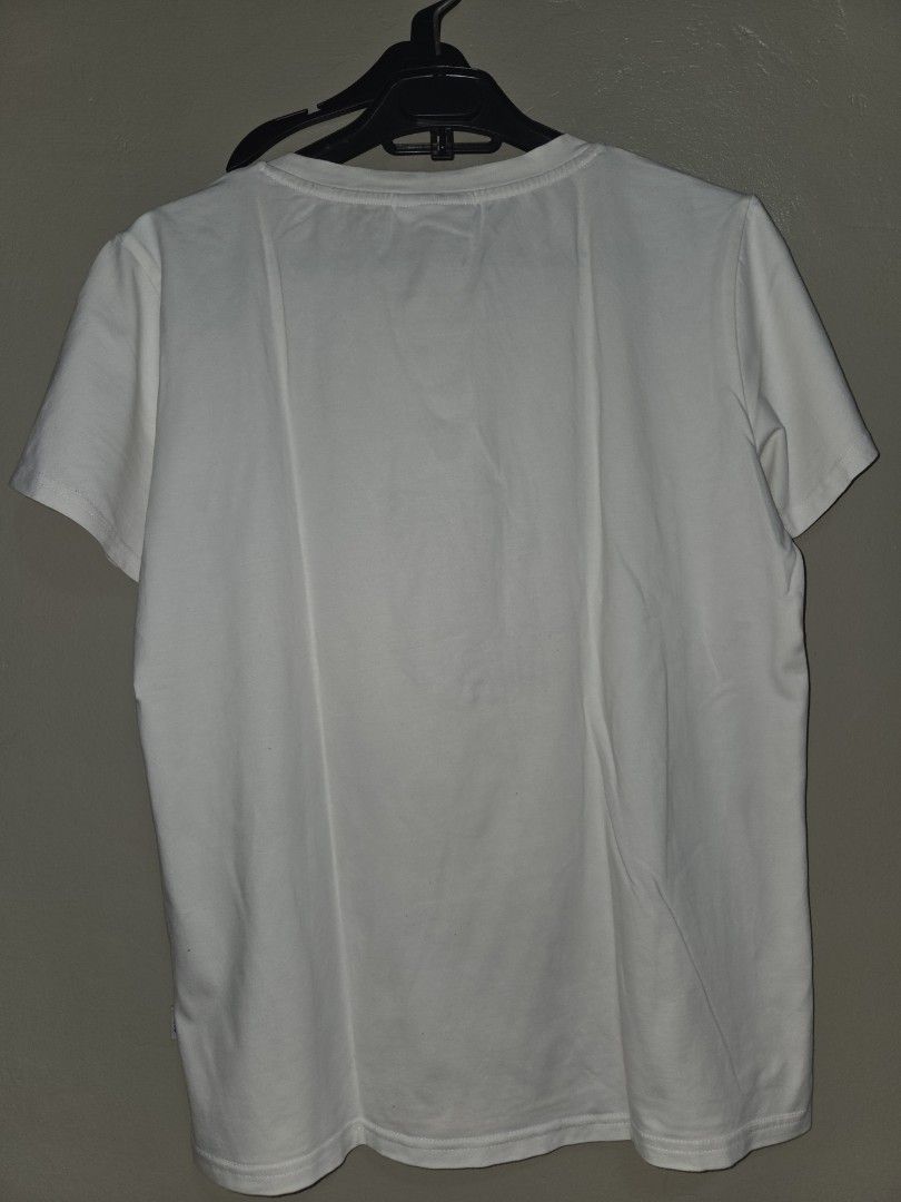 Vans White T-Shirt with Embroidered Cat Graphic (Category: Shirts) located in Quezon City. Submitted by klarebear15 (Listing ID 1468024600, Image 2). Description: - Brand: Vans - Color: White - Material: Soft, comfortable cotton - Design: Center chest embroidered cat graphic with blue outlines and orange ears - Details: Small woven Vans logo tab on the right hem - Fit/Style: Classic crew neck, standard hem, great casual streetwear basic - Conditi