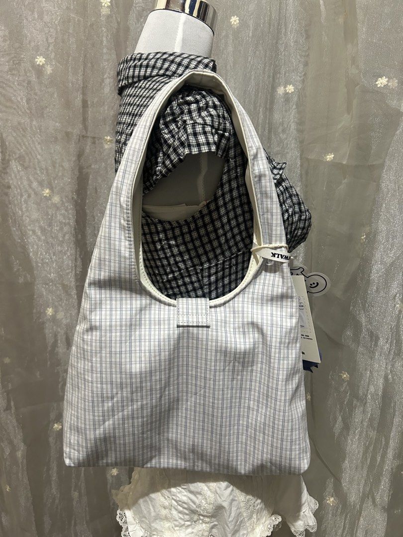 Vanwalk Reversible Plaid and White Shoulder Bag (Category: Shoulder Bags) located in Tuguegarao City. Submitted by eliwyxzs (Listing ID 1467841632, Image 2). Description: - Brand: Vanwalk - Style: Reversible shoulder bag - Side A: Blue and white plaid pattern with pocket and flower embroidery - Side B: Plain white with subtle embossed branding - Inclusions: Original tags attached + adorable blue berry plush charm - Features: Soft, comfortable sho