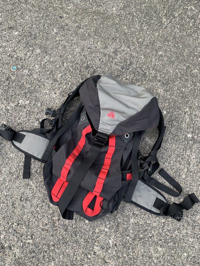 Vintage 90’s Nike ACG Backpack (Category: Backpacks) located in Cebu City. Submitted by ninyothrift (Listing ID 1467925786, Image 2). Description: - Authentic Nike ACG backpack in a stylish black, grey, and red colorway - Durable ripstop grid pattern on the main body - Embroidered ACG logo on the top flap - Multiple adjustable straps and sturdy buckles for a secure fit - Padded mesh back panel for extra comfort and support - Functional compartmen