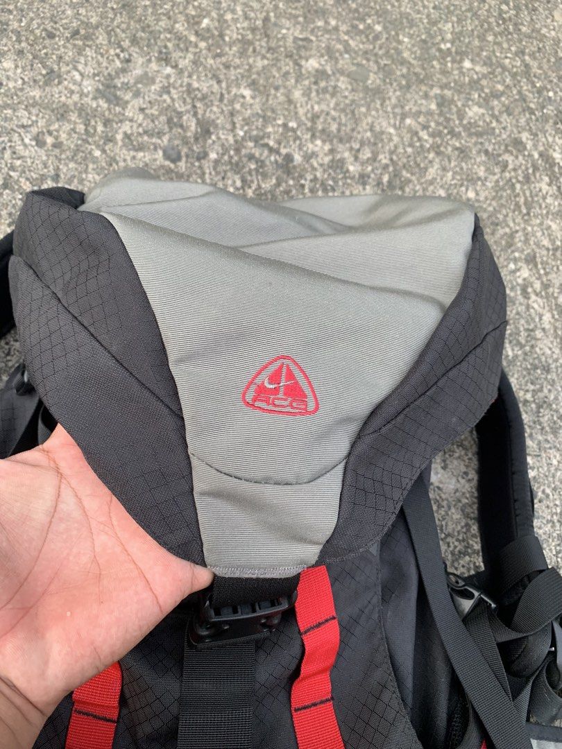 Vintage 90’s Nike ACG Backpack (Category: Backpacks) located in Cebu City. Submitted by ninyothrift (Listing ID 1467925786, Image 3). Description: - Authentic Nike ACG backpack in a stylish black, grey, and red colorway - Durable ripstop grid pattern on the main body - Embroidered ACG logo on the top flap - Multiple adjustable straps and sturdy buckles for a secure fit - Padded mesh back panel for extra comfort and support - Functional compartmen