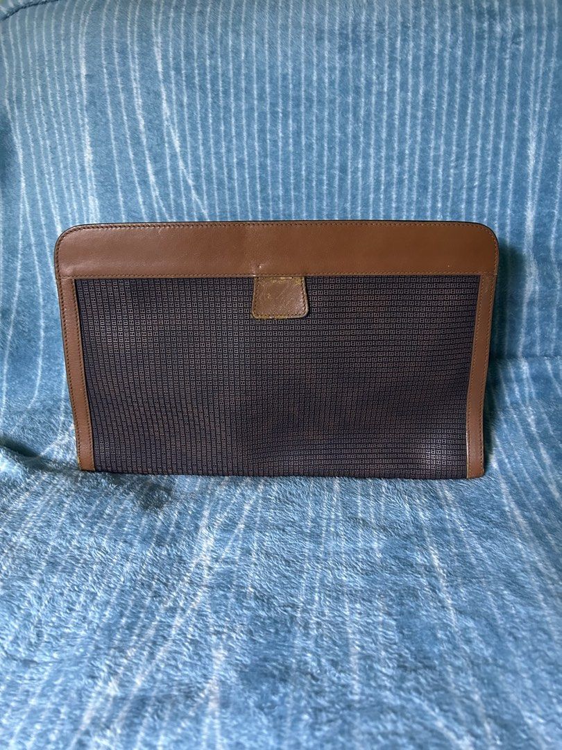 Vintage Bally Monogram Clutch Bag Brown (Category: Purses & Pouches) located in Quezon City. Submitted by thriftxgoods (Listing ID 1467891580, Image 2). Description: - Authentic vintage Bally clutch bag in classic brown monogram canvas - Features stylish leather trim and a subtle debossed 'B' logo on the front - Secure Velcro closure with expandable gusseted sides for extra space - Luxurious smooth tan leather interior with official Bally brand s