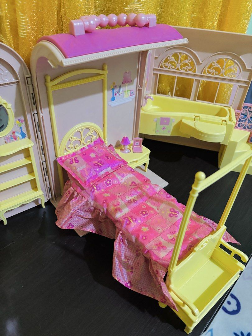 Barbie Doll House Bed And Bath Playset (Category: Kids Toys) located in Lucban. Submitted by quinsdollhouse (Listing ID 1468018665, Image 2). Description: Barbie Sweet Dreams Bed & Bath House - Pink and yellow folding dollhouse with convenient storage design - Features a cozy canopy bed and nightstand with lamp and alarm clock - Includes a wardrobe with mirror and a yellow bathroom vanity with stairs - Decorated with charming pink butterfly beddi