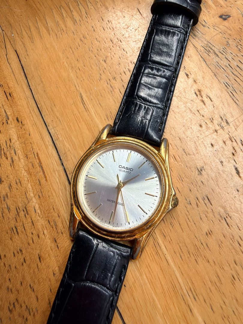 Vintage Casio Quartz Watch Gold Tone Silver Dial (Category: Women's Watches) located in Quezon City. Submitted by 30somethingtreasures (Listing ID 1467994555, Image 1). Description: - Brand: Casio - Movement: Quartz - Design: Gold-tone case with a sunburst silver dial - Strap: Black faux leather with croc-embossed texture and standard pin buckle - Features: Water resistant, gold hands and hour markers - Style: Classic dress watch, perfect for any
