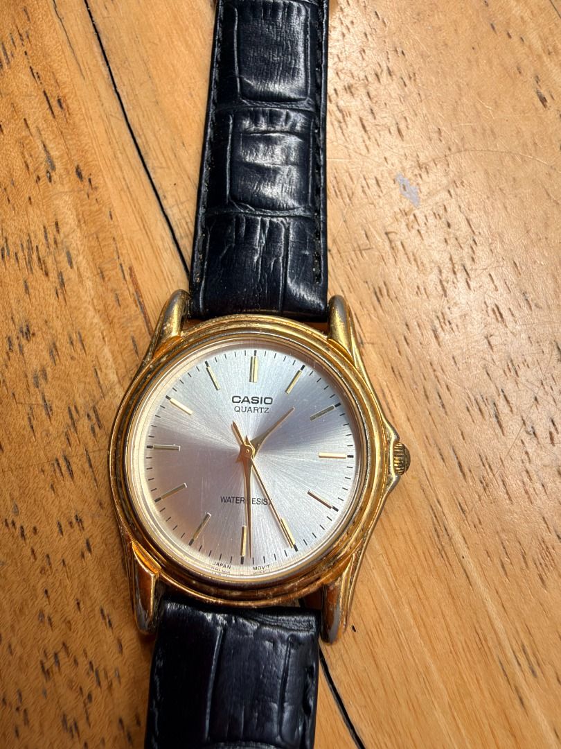 Vintage Casio Quartz Watch Gold Tone Silver Dial (Category: Women's Watches) located in Quezon City. Submitted by 30somethingtreasures (Listing ID 1467994555, Image 3). Description: - Brand: Casio - Movement: Quartz - Design: Gold-tone case with a sunburst silver dial - Strap: Black faux leather with croc-embossed texture and standard pin buckle - Features: Water resistant, gold hands and hour markers - Style: Classic dress watch, perfect for any