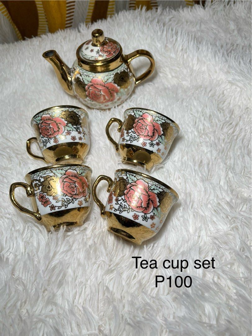 Vintage Ceramic Tea Pot Set with 4 Cups (Category: Coffee & Tea Tableware) located in Makati City. Submitted by mjaca03 (Listing ID 1467970112, Image 1). Description: - Elegant ceramic tea set including 1 teapot with lid and 4 matching cups - Beautiful white base adorned with classic pink rose floral prints - Luxurious shiny gold trim accents for a sophisticated touch - Perfect for afternoon tea parties, gatherings, or kitchen display - Fast ship