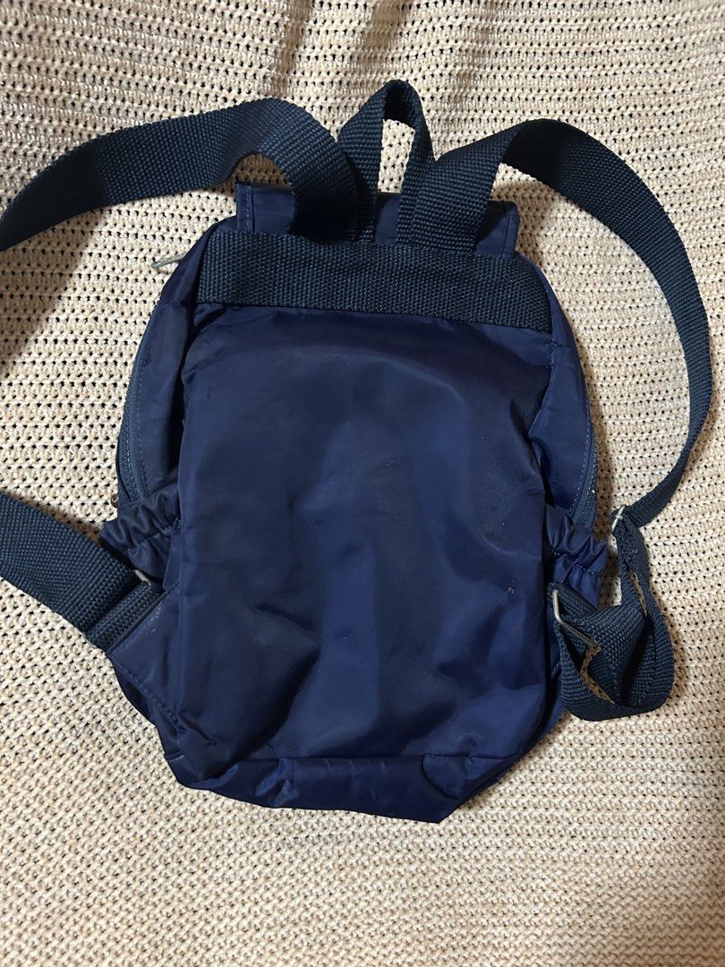 Vintage Kipling Navy Blue Backpack with Monkey Keychain (Category: Backpacks) located in Pasig City. Submitted by mixpicks (Listing ID 1467857509, Image 3). Description: - Color: Dark Blue - Material: Lightweight, durable nylon - Closure: main compartment with secure flap cover - Pockets: Front zippered pocket with snap flap cover and convenient side pockets - Comfort: Adjustable shoulder straps for a custom fit - Inclusion: Comes with the iconic