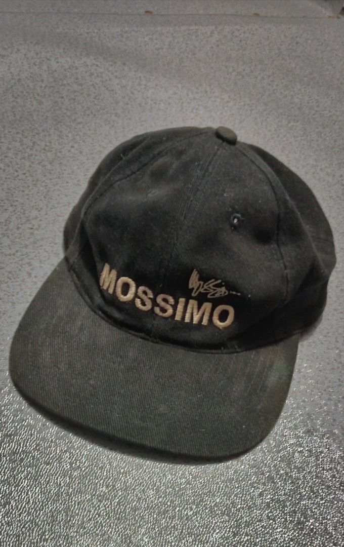 Vintage Mossimo Black Cap (Category: Caps & Hats) located in Manila. Submitted by ianmontede19006 (Listing ID 1467867939, Image 1). Description: - Brand: Mossimo - Color: Black with embroidered logo and side 'm' emblem - Fit: Adjustable strap back closure with quality KAM hardware - Design: Classic curved brim and structured crown - Condition: Shows visible signs of wear and fading from age and use (interior tag intact) - Style: Streetwear / Casu
