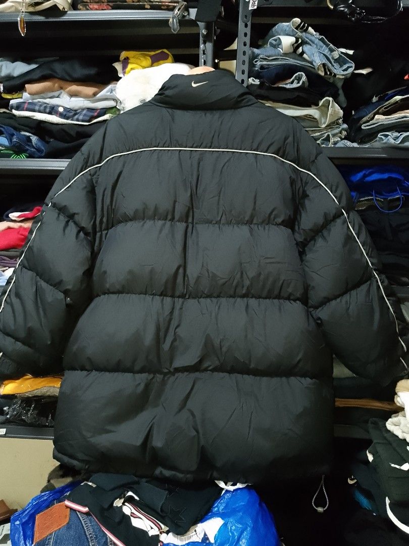 Vintage Nike Black Puffer Jacket Size L (Category: Coats, Jackets and Outerwear) located in Manila. Submitted by mjthrifted_second (Listing ID 1467894412, Image 2). Description: - Brand: Nike -Dimes: 26/32 - Style: Puffer jacket with full zip front closure and branded zipper pulls - Color: Black with grey fleece inner collar and white piping details - Branding: Embroidered Nike swoosh logo on front and back - Size: L (Tag on collar) - Origin: Mad