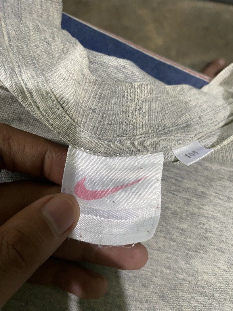 Vintage Nike Grey Graphic Tee Split Logo Front Back (Category: Tshirts & Polo Shirts ) located in Tiaong. Submitted by maticbuy (Listing ID 1467983330, Image 3). Description: - Brand: Nike - Color: Heather Grey - Size: Large - Design: Large red graphics on front bottom; large blue graphics with mini swoosh on back bottom - Fit: Relaxed fit with classic crew neck - Condition: Excellent casual wear piece .