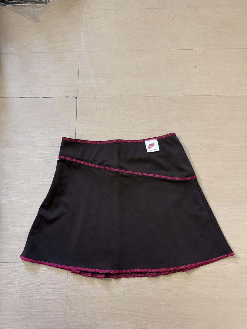 Vintage Nike Sport (Category: Skirts) located in Manila. Submitted by juhjuh (Listing ID 1467908229, Image 3). Description: - Brand: Nike - Style: Athletic skirt with pleated design and solid back panel - Color: Black with pink contrast stitching - Details: Orange and pink Nike logo on front waist - Size: S (tag attached) - Material: 100% polyester - Condition: Brand new / Excellent .