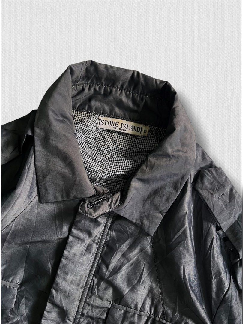 Vintage stone island jacket (Category: Hiking & Camping) located in Cebu City. Submitted by northdrip.threadd (Listing ID 1467905439, Image 3). Description: - Brand: Stone Island - Size: XL - Color: Dark Grey / Black - Style: Vintage utility jacket with multiple front pockets and epaulets - Interior: Classic houndstooth pattern lining - Condition: Well-preserved vintage piece with clear branding tags.