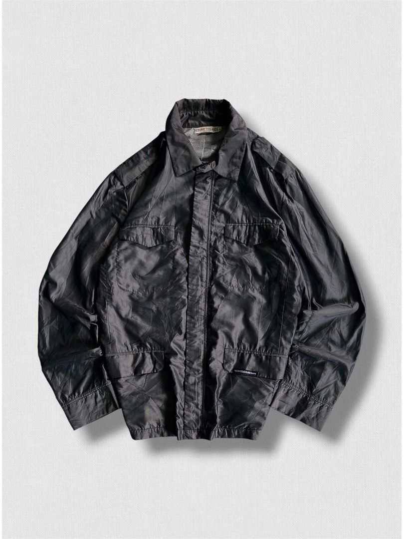 Vintage stone island jacket (Category: Hiking & Camping) located in Cebu City. Submitted by northdrip.threadd (Listing ID 1467905439, Image 1). Description: - Brand: Stone Island - Size: XL - Color: Dark Grey / Black - Style: Vintage utility jacket with multiple front pockets and epaulets - Interior: Classic houndstooth pattern lining - Condition: Well-preserved vintage piece with clear branding tags.