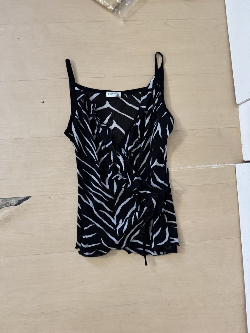 Vintage Top (Category: Sleeveless) located in Manila. Submitted by juhjuh (Listing ID 1467908467, Image 1). Description: - Brand: Show Biz Paris - Pattern: Black and white zebra print all over - Design: Thin spaghetti straps, ruffled neckline trim, and wrap-style front - Origin: Made in France - Care: Dry clean only (light weight) - Condition: Great condition (ready to wear!).