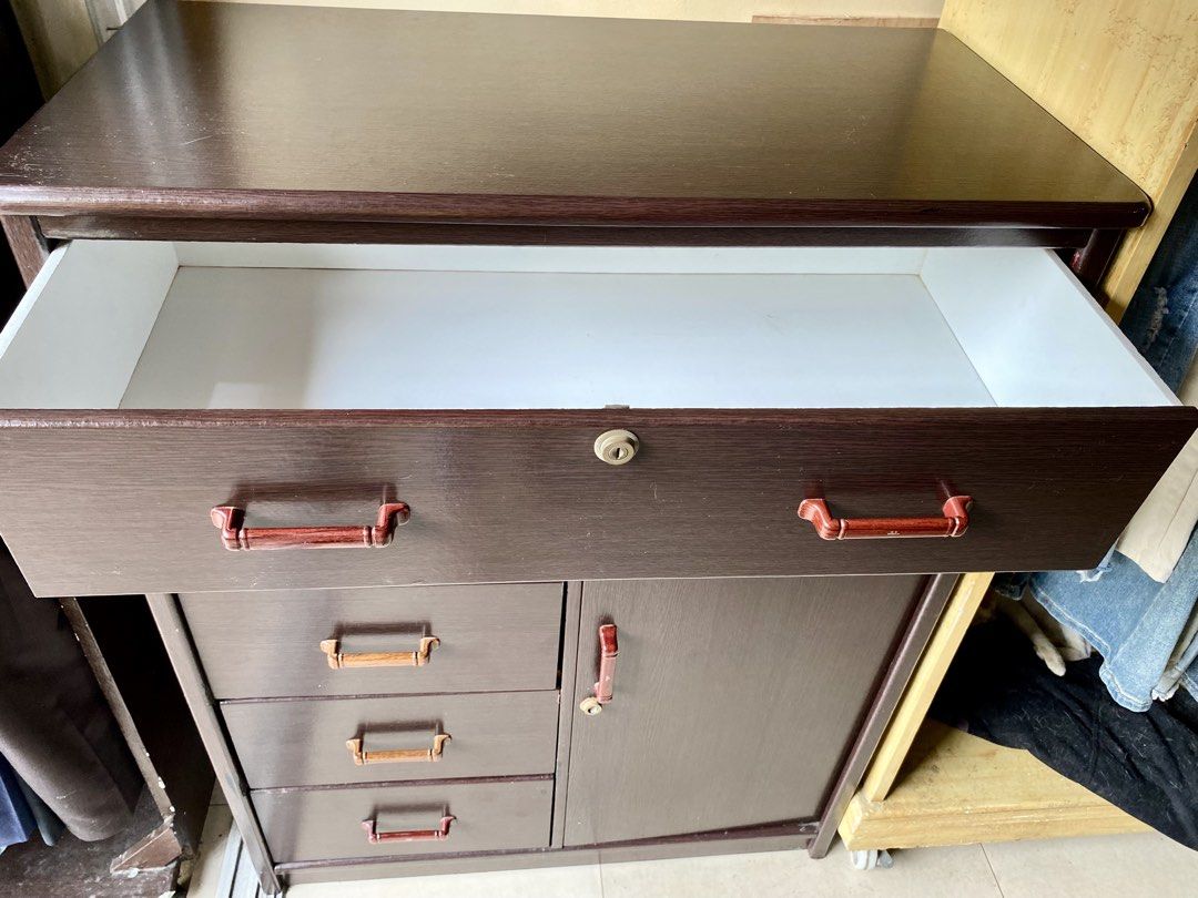 Wardrobe Cabinet with Drawers ( pre-loved) (Category: Shelves, Cabinets & Racks) located in Manila. Submitted by muqin_chimary (Listing ID 1467910836, Image 2). Description: Measurements : H110 x W86 x D44cm ✔️Wood grain ✔️ Multiple drawers for organized storage ✔️ Spacious cabinet compartment ✔️ Classic dark brown finish ✔️ Space-saving and practical design 📌 Pre-loved condition with some minimal signs of use. 💰 Price: ₱2,000 🚚 Buyer will sho