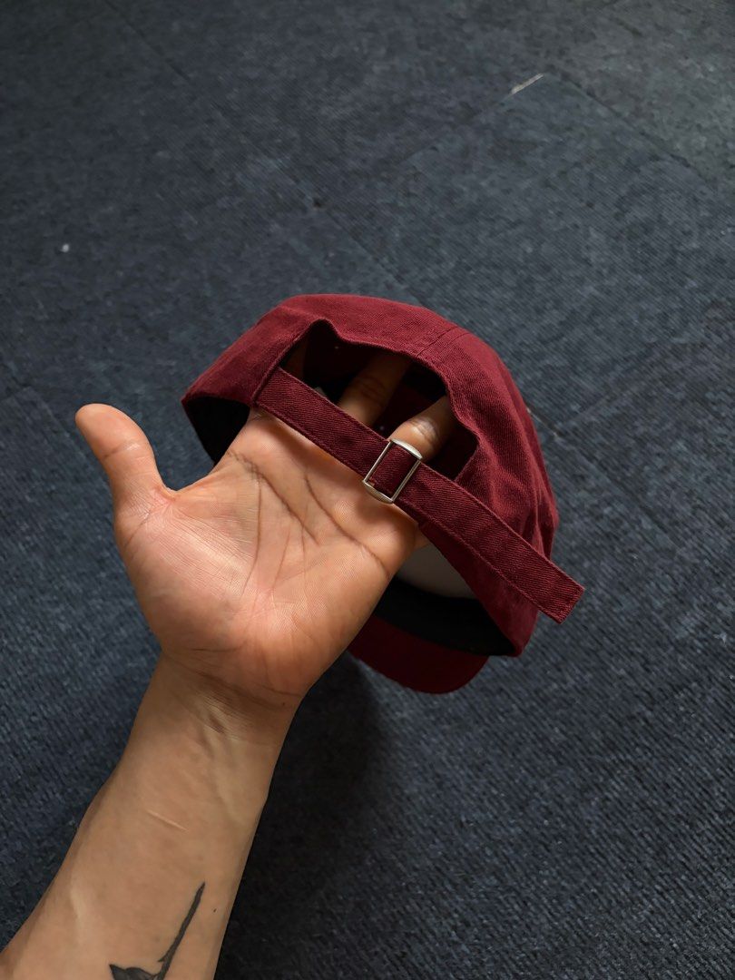 WASC House Collection Maroon Cap (Category: Caps & Hats) located in Manila. Submitted by toys_hats005 (Listing ID 1467956512, Image 2). Description: - Brand: WASC House Collection - Color: Maroon with white graphic print - Material: 100% cotton interior with a comfortable black sweatband - Fit: Adjustable strap closure with a silver-tone metal buckle - Condition: Clean fabric, shape retainer insert still inside.