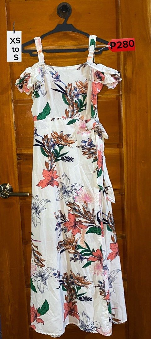 White Floral Cold Shoulder Maxi Dress (Category: Dresses) located in Baguio. Submitted by heath2600 (Listing ID 1468030382, Image 1). Description: - Color/Pattern: White with vibrant colorful floral print - Design: Cold shoulder style with ruffled short sleeves and spaghetti straps - Details: Adjustable tie wrap detail at the waist - Fabric: Lightweight and breathable, ideal for sunny days or beach getaways - Fit: Comfortably fits Extra Small to 