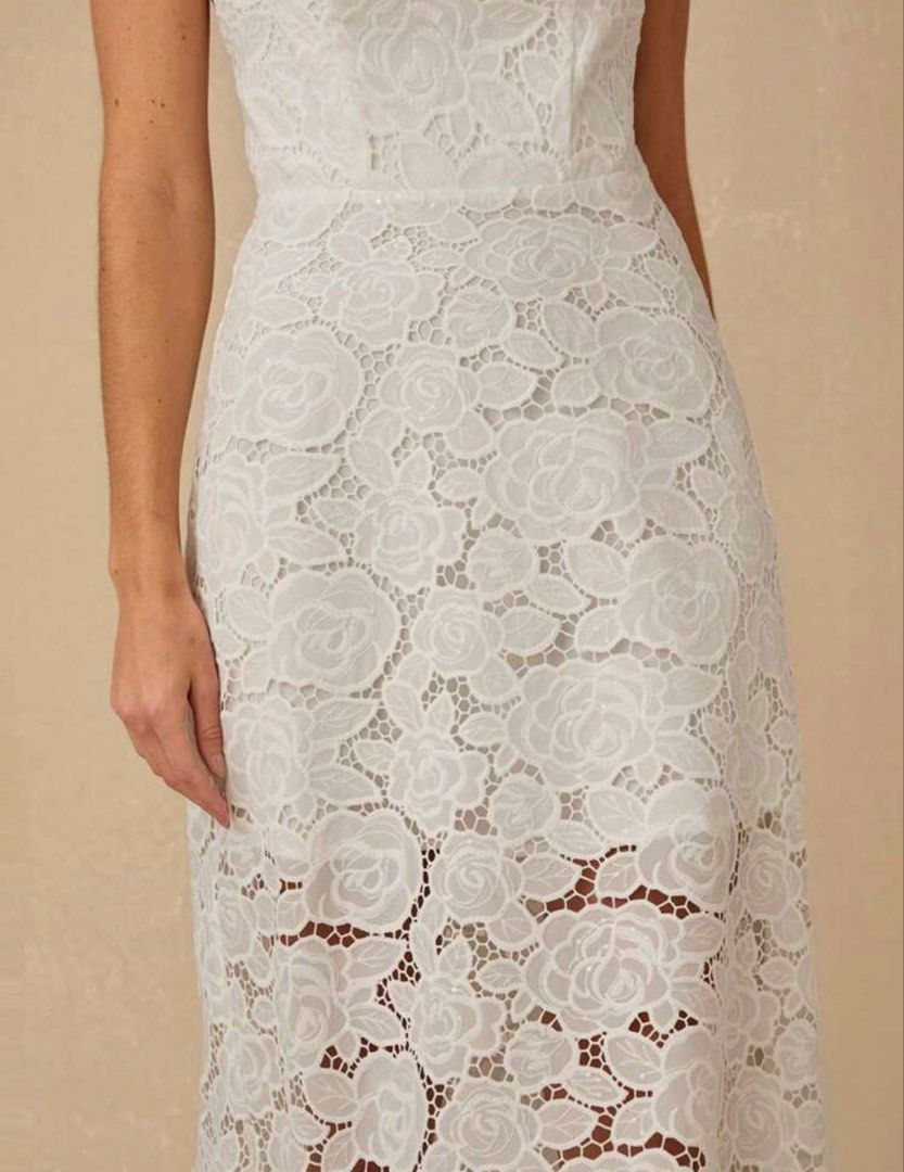 White Lace Midi Dress Open Back Spaghetti Strap (Category: Dresses) located in Quezon City. Submitted by shop_mnl (Listing ID 1467971692, Image 3). Description: - Color: True White - Material: Delicate floral lace with full lining on the top portion - Design: Square neckline, thin spaghetti straps, fitted bodice, and flared skirt with a sheer hem - Back Details: Trendy strappy open back with horizontal straps - Versatile Style: Perfect for partie