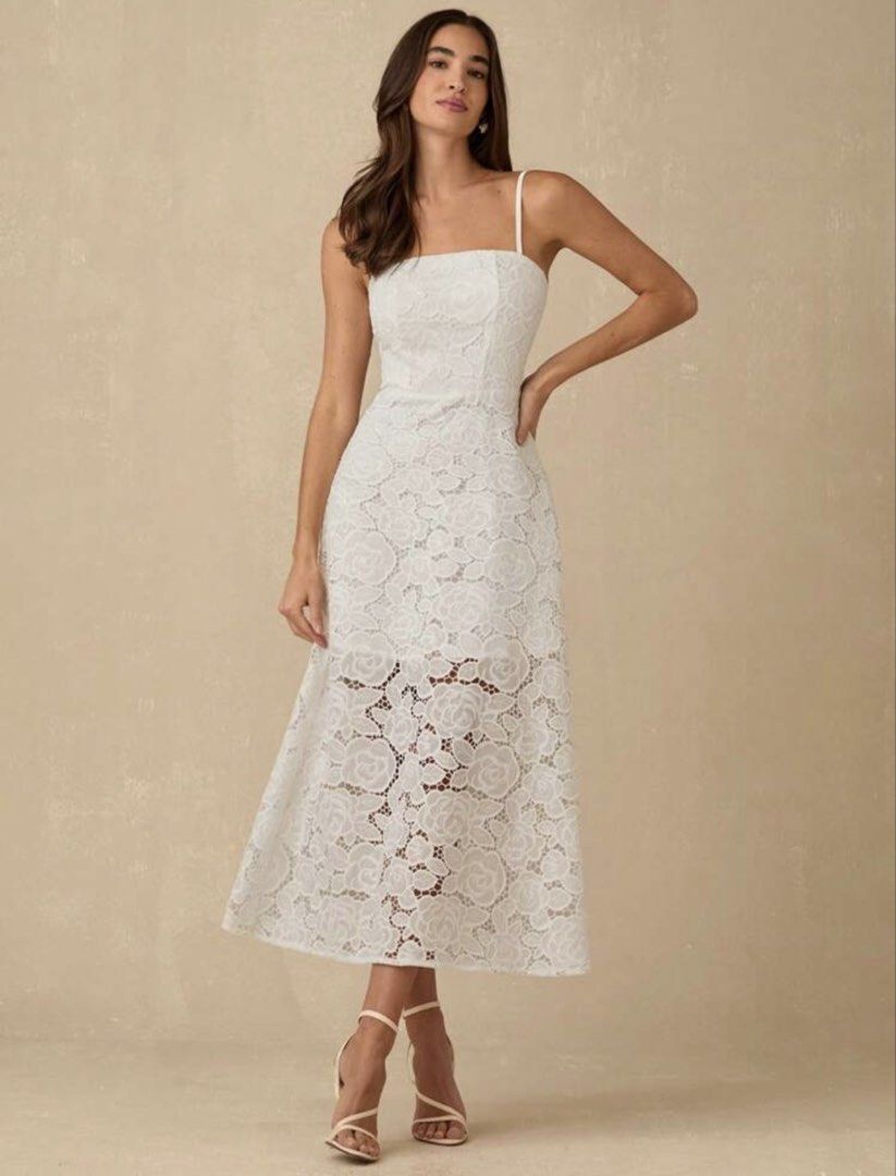 White Lace Midi Dress Open Back Spaghetti Strap (Category: Dresses) located in Quezon City. Submitted by shop_mnl (Listing ID 1467971692, Image 1). Description: - Color: True White - Material: Delicate floral lace with full lining on the top portion - Design: Square neckline, thin spaghetti straps, fitted bodice, and flared skirt with a sheer hem - Back Details: Trendy strappy open back with horizontal straps - Versatile Style: Perfect for partie