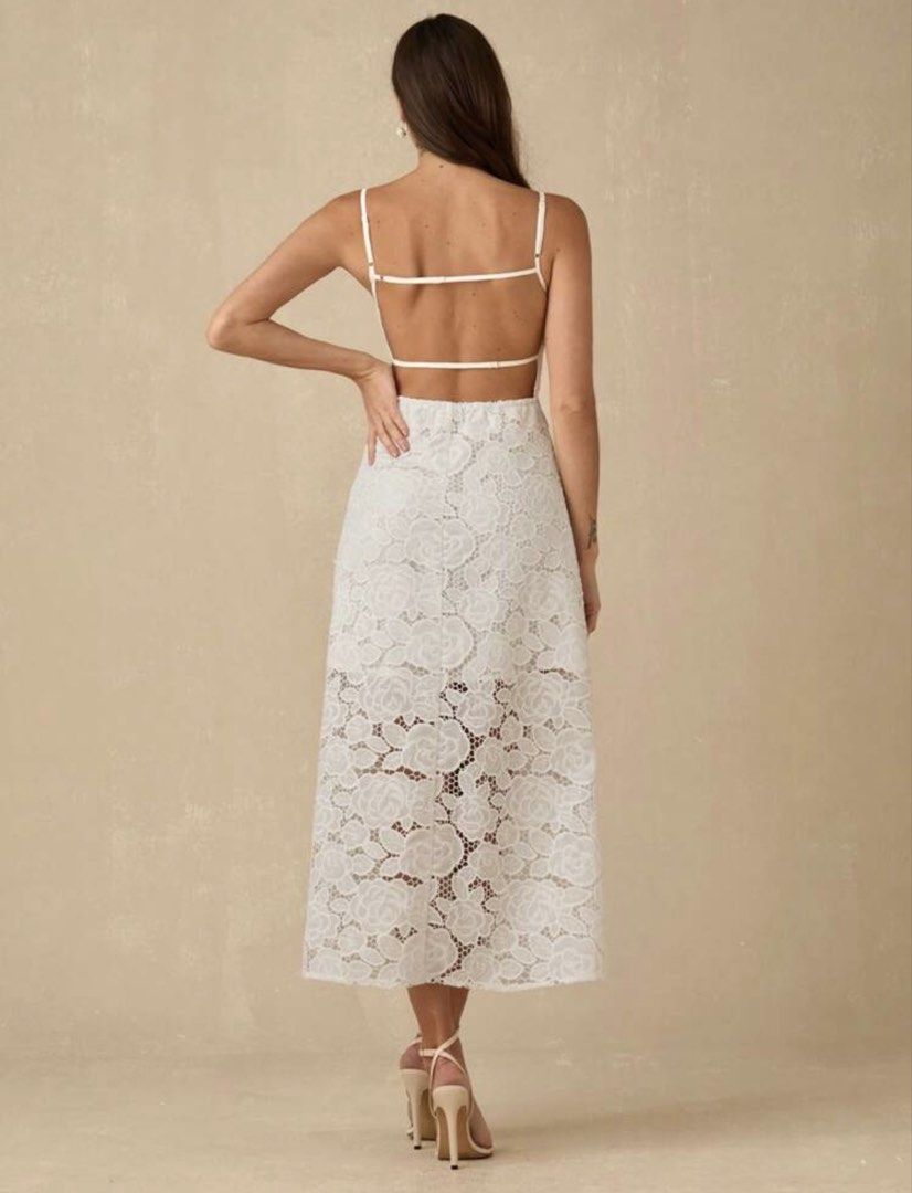 White Lace Midi Dress Open Back Spaghetti Strap (Category: Dresses) located in Quezon City. Submitted by shop_mnl (Listing ID 1467971692, Image 2). Description: - Color: True White - Material: Delicate floral lace with full lining on the top portion - Design: Square neckline, thin spaghetti straps, fitted bodice, and flared skirt with a sheer hem - Back Details: Trendy strappy open back with horizontal straps - Versatile Style: Perfect for partie
