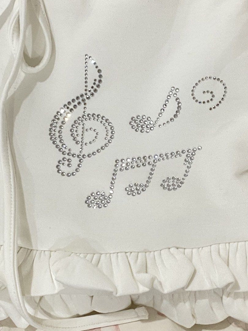White Ruffle Skirt with Rhinestone Music Notes (Category: Skirts) located in Manila. Submitted by pinkpolly.mnla (Listing ID 1467950943, Image 2). Description: White mini skirt with rhinestone music notes and built in shorts from Japan 🎀 - size small and doesn’t come with a tag - no stains or tears - comes with shorts inside - in perfect condition 🎀 PLEASE READ ! 🎀 🎀 MOP : GCASH or Bank transfer 🎀 MOD : Lalamove 🎀 Buyer pays for shipping 🎀
