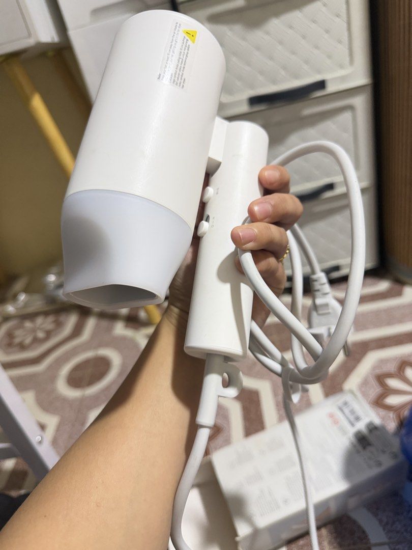 Xiaomi Compact Hair Dryer H101 (Category: Hair) located in Las Pinas. Submitted by sugaaarr (Listing ID 1467863459, Image 2). Description: - Model: Xiaomi Compact Hair Dryer H101 (White) - Condition: Tested and fully working - Design: Lightweight with a convenient foldable handle for easy travel - Controls: Multiple speed and temperature settings located on the handle - Inclusions: Comes with original box and standard power cord.