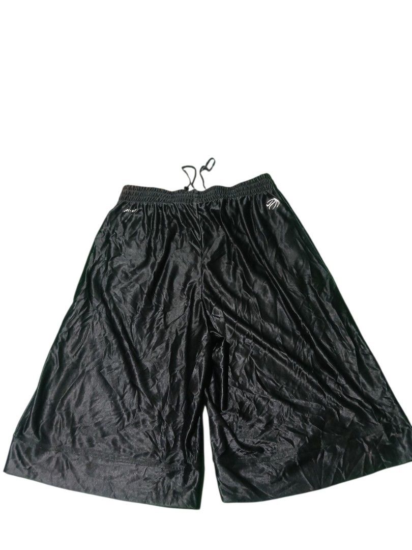 Y2k Nike shiny baller short (Category: Shorts) located in San Jose. Submitted by garments17 (Listing ID 1467970007, Image 2). Description: - Color: Sleek black with a glossy satin-like finish - Branding: Nike swoosh on the lower left leg and basketball graphic near the back waistband - Technology: Dri-FIT fabric keeps you dry and cool during workouts - Fit: Elastic waistband with adjustable drawstring for a secure fit - Comfort: Loose, wide-leg c