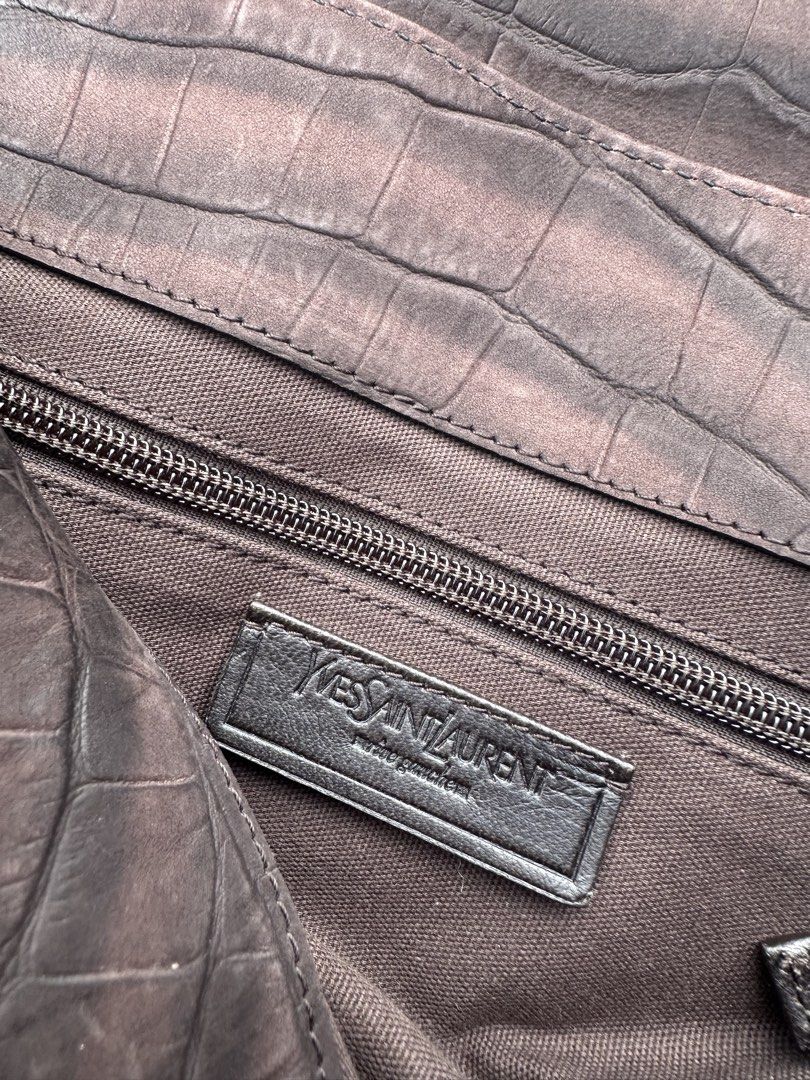Yves Saint Laurent (YSL) Muse Messenger Bag (Category: Sling Bags) located in San Pedro. Submitted by jiniestuff (Listing ID 1467843831, Image 2). Description: Original YSL Muse Messenger Bag Material/Finish: Crafted with crocodile-embossed leather or patent leather detailing paired with canvas/fabric bodies. Features: Flap-top closure with snap buttons, an adjustable canvas/webbing shoulder strap, side hardware rings, and the signature structure