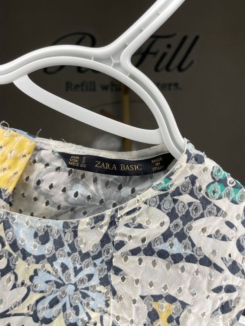 Zara Basic Sleeveless Patterned Top Size S (Category: Sleeveless) located in Taguig. Submitted by re.wear.mnl (Listing ID 1468004183, Image 3). Description: - Brand: Zara Basic - Size: S - Material: 100% Cotton - Design: Eyelet perforated texture with multi-color blue, yellow, and black floral pattern - Neckline: Round neckline - Features: Lightweight, sleeveless, made in Spain - Condition: Excellent pre-loved / Brand new (ready to wear).