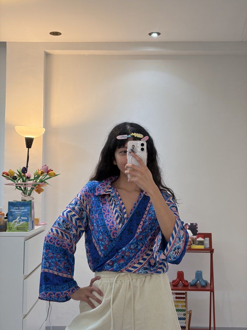 Zara Blue Floral Wrap Blouse Size S (Category: Blouses) located in Quezon City. Submitted by prelovedbynxkole (Listing ID 1467884704, Image 3). Description: - Brand: Zara - Size: S (Made in Morocco) - Condition: Brand new, but lost tag haha - Color/Pattern: Blue with pink floral and geometric prints - Style: Wrap front design, lapel collar, and long bell sleeves - Perfect for: Casual days out, easily styled with high-waisted pants or skirts ALL C