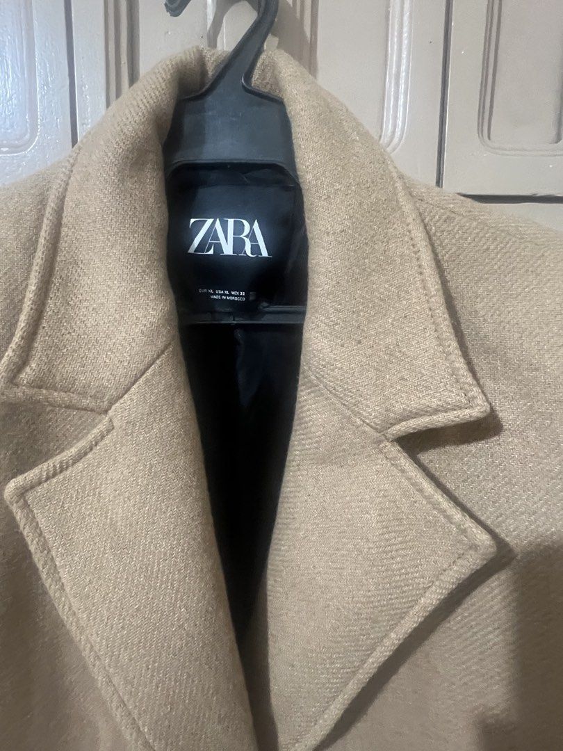 Zara Camel Long Wool Coat Size XL (Category: Coats, Jackets and Outerwear) located in Pasay City. Submitted by sharshay317 (Listing ID 1468056455, Image 2). Description: Zara camel long coat in size XL. Classic lapel collar with front button closure. Two functional front welt pockets. Matching buttons on sleeve cuffs. Neutral beige herringbone texture fabric. Timeless winter outerwear piece. Warm, thick material. Clean interior lining. Bought thi