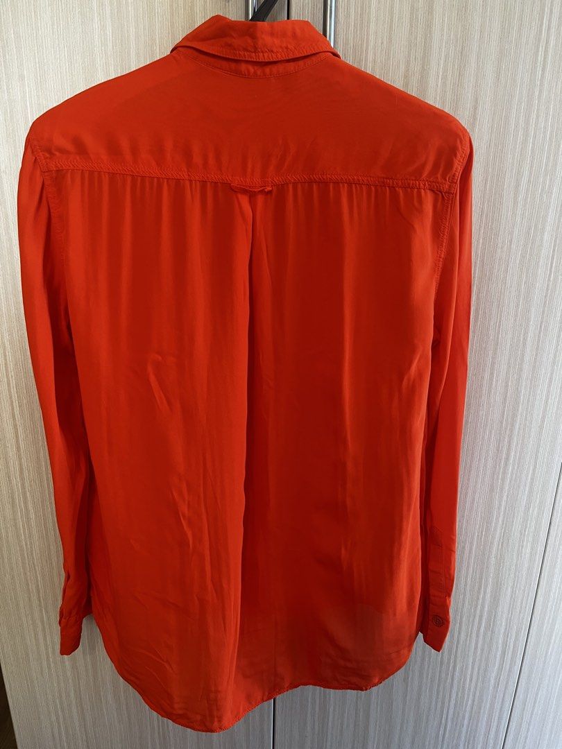 Zara Orange Long Sleeve Button-Up Shirt (Category: Longsleeves) located in Manila. Submitted by lorenasant37621 (Listing ID 1467910549, Image 2). Description: - Brand/Style: Zara vibrant orange button-down shirt - Size: S (Made in Turkey) - Features: Long sleeves with button cuffs, classic collar, and two front chest pockets - Fabric: Lightweight with a subtle sheen - Hem: Rounded hemline (great for tucking in or wearing loose) - Condition: Clean