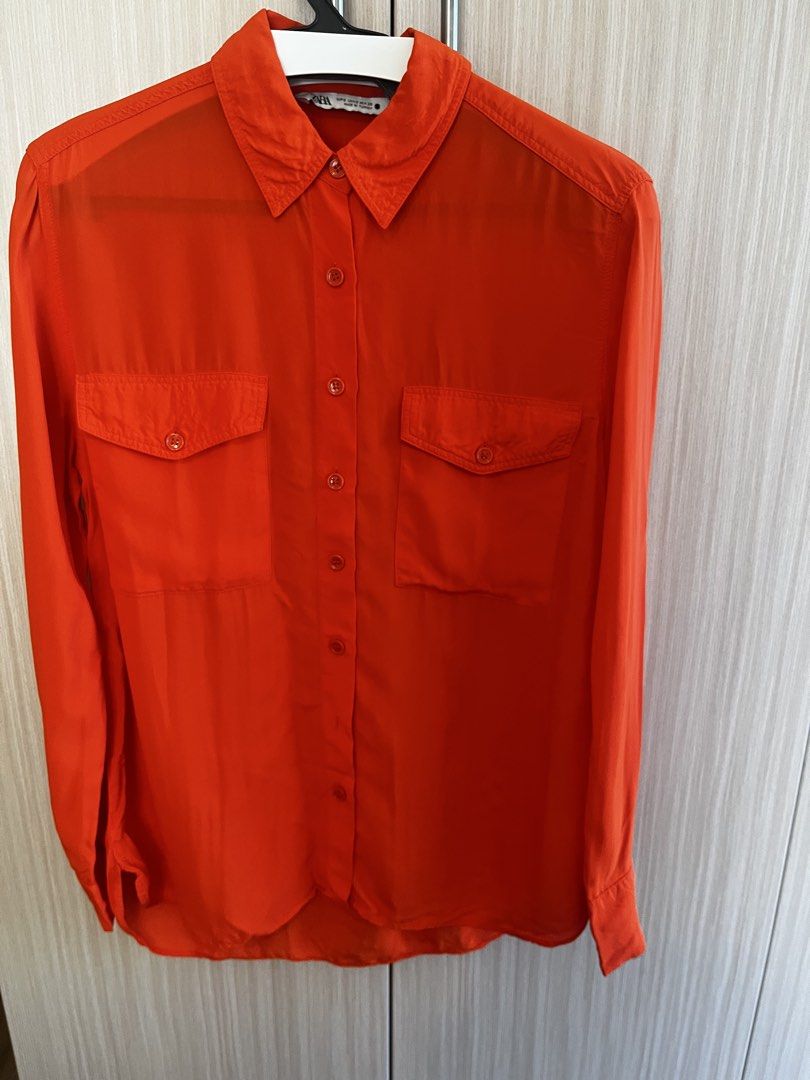 Zara Orange Long Sleeve Button-Up Shirt (Category: Longsleeves) located in Manila. Submitted by lorenasant37621 (Listing ID 1467910549, Image 1). Description: - Brand/Style: Zara vibrant orange button-down shirt - Size: S (Made in Turkey) - Features: Long sleeves with button cuffs, classic collar, and two front chest pockets - Fabric: Lightweight with a subtle sheen - Hem: Rounded hemline (great for tucking in or wearing loose) - Condition: Clean