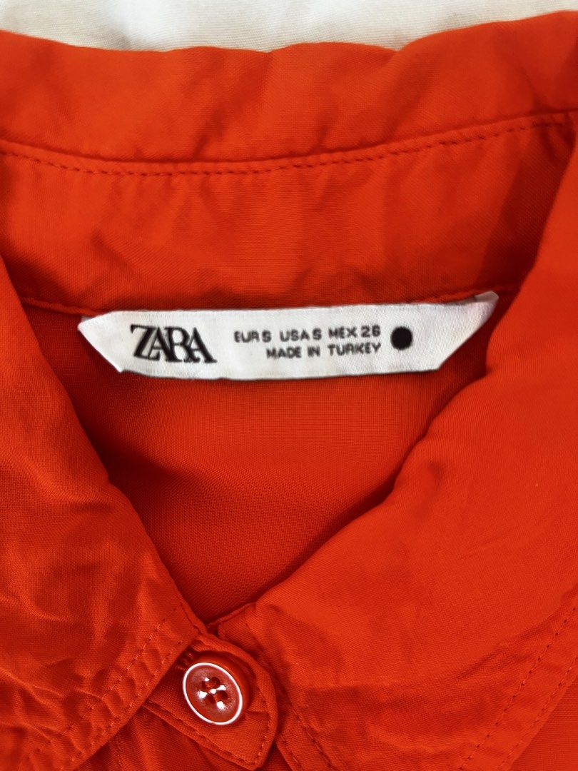 Zara Orange Long Sleeve Button-Up Shirt (Category: Longsleeves) located in Manila. Submitted by lorenasant37621 (Listing ID 1467910549, Image 3). Description: - Brand/Style: Zara vibrant orange button-down shirt - Size: S (Made in Turkey) - Features: Long sleeves with button cuffs, classic collar, and two front chest pockets - Fabric: Lightweight with a subtle sheen - Hem: Rounded hemline (great for tucking in or wearing loose) - Condition: Clean