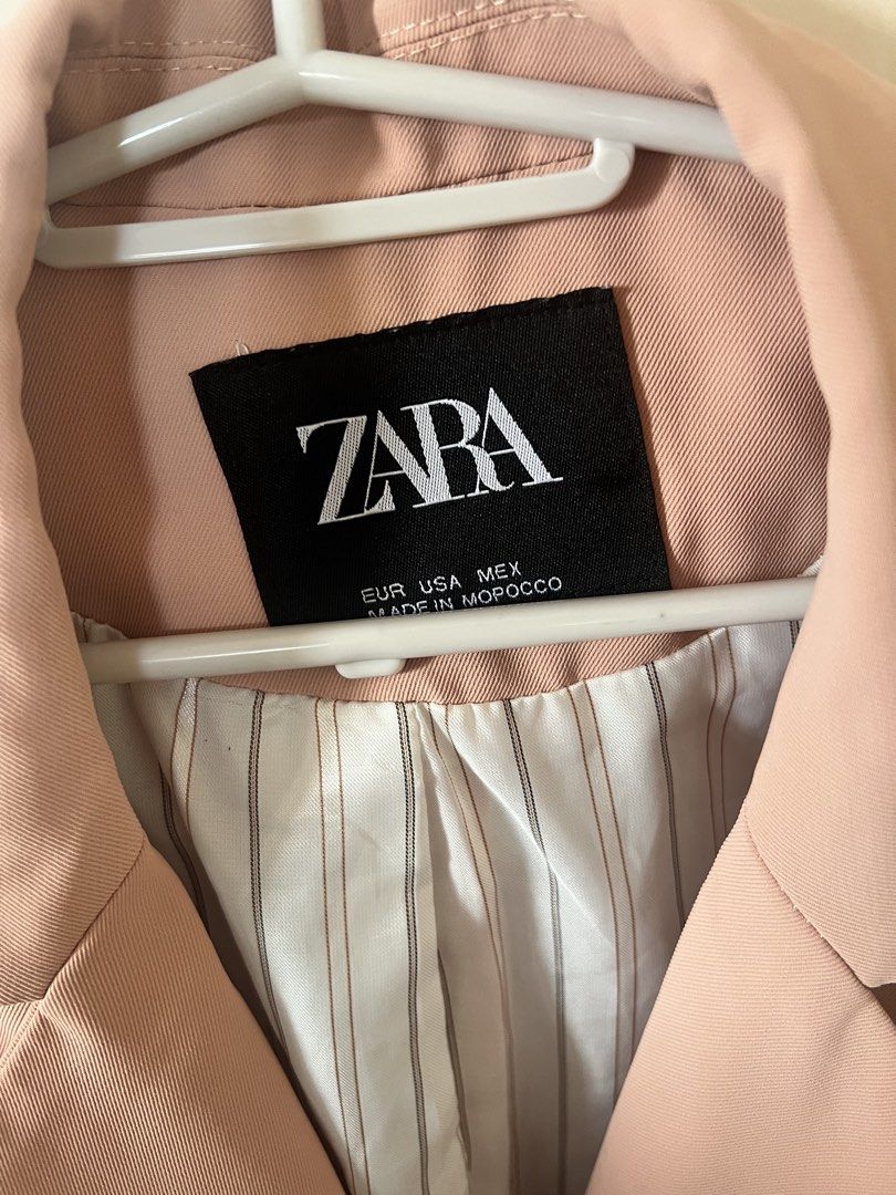 Zara Pink Blazer (Category: Coats, Jackets and Outerwear) located in Pasig City. Submitted by notyouraveragestuff (Listing ID 1467851349, Image 2). Description: - Brand: Zara - Color: Dusty Pink - Origin: Made in Morocco - Design: Classic lapel collar with double-button front closure - Pockets: Two front flap pockets and a small chest pocket detail - Lining: Stylish white and brown vertical stripe interior - Style: Great structured layering piece