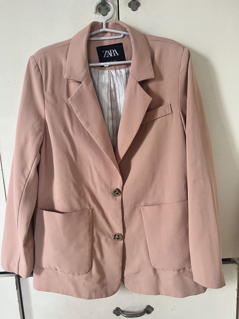 Zara Pink Blazer (Category: Coats, Jackets and Outerwear) located in Pasig City. Submitted by notyouraveragestuff (Listing ID 1467851349, Image 1). Description: - Brand: Zara - Color: Dusty Pink - Origin: Made in Morocco - Design: Classic lapel collar with double-button front closure - Pockets: Two front flap pockets and a small chest pocket detail - Lining: Stylish white and brown vertical stripe interior - Style: Great structured layering piece
