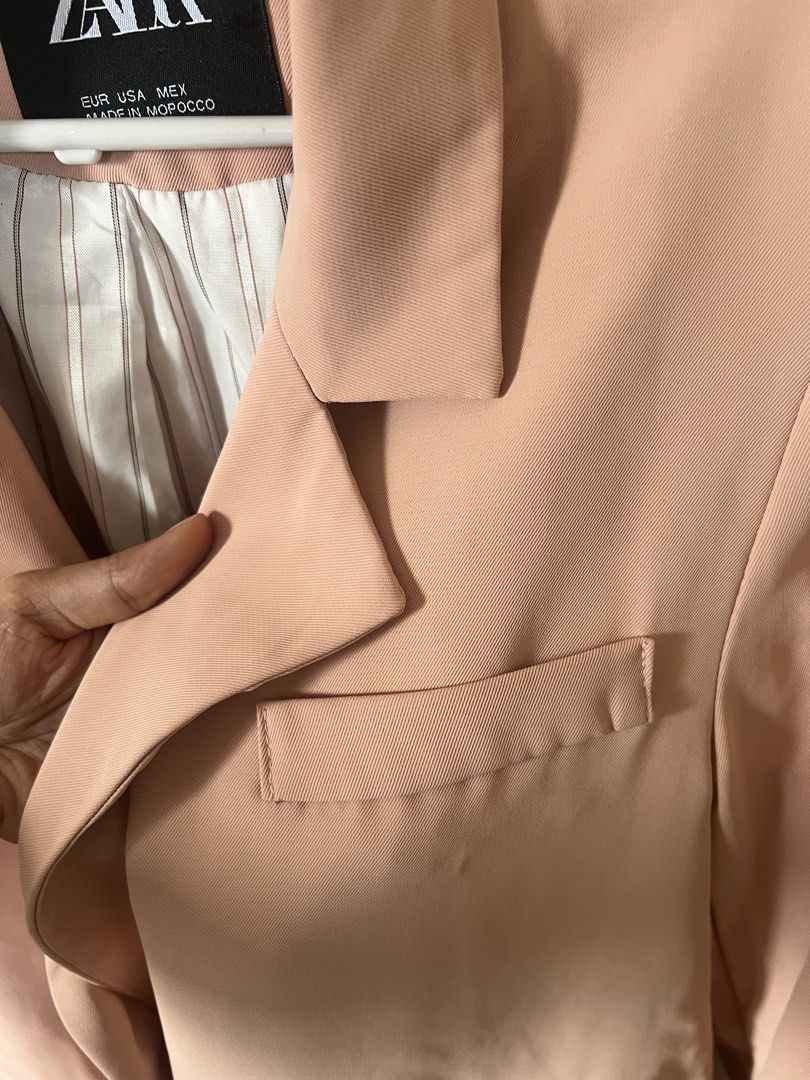 Zara Pink Blazer (Category: Coats, Jackets and Outerwear) located in Pasig City. Submitted by notyouraveragestuff (Listing ID 1467851349, Image 3). Description: - Brand: Zara - Color: Dusty Pink - Origin: Made in Morocco - Design: Classic lapel collar with double-button front closure - Pockets: Two front flap pockets and a small chest pocket detail - Lining: Stylish white and brown vertical stripe interior - Style: Great structured layering piece