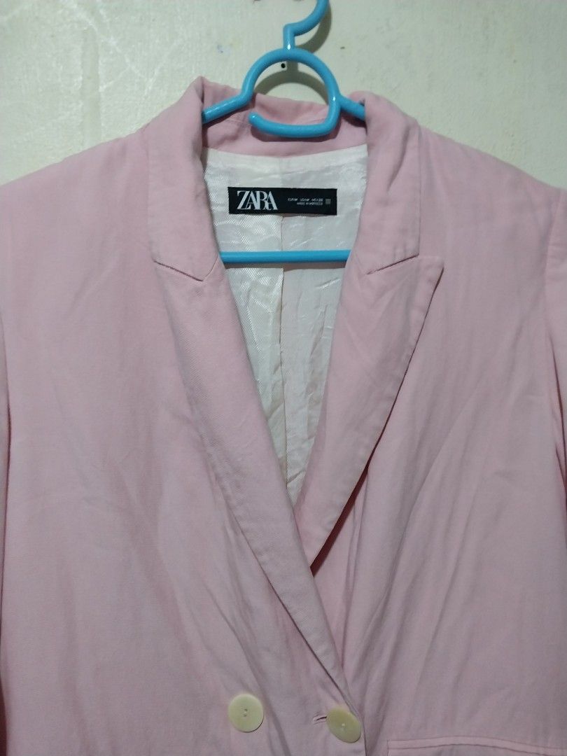 Zara Pink Blazer Jacket Size M (Category: Coats, Jackets and Outerwear) located in Manila. Submitted by PrinceDani.Clothing (Listing ID 1467965778, Image 3). Description: - Brand: Zara - Size: M - Color: Light pink - Material: Comfortable cotton-blend fabric - Design: Double-breasted front with two light buttons - Pockets: Two front patch pockets - Details: Classic lapel collar and chic white patterned lining - Styling: Great layering piece for b