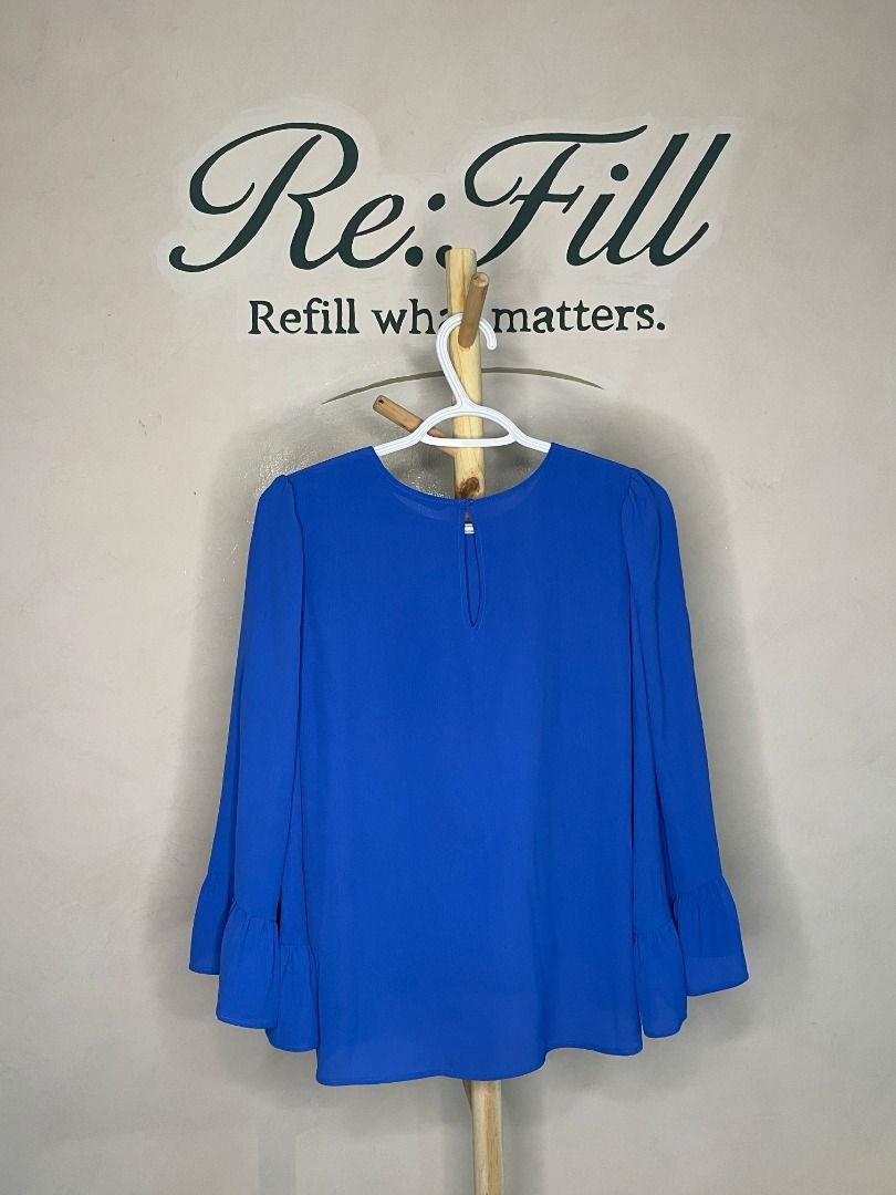 Zara Royal Blue Long Sleeve Blouse (Category: Longsleeves) located in Taguig. Submitted by re.wear.mnl (Listing ID 1468006857, Image 2). Description: - Brand: Zara - Color: Bright Royal Blue - Size / Fit: Round neckline with shoulder gathers and flared bell sleeves - Material: 100% lightweight polyester (Made in Turkey) - Condition: Clean, excellent overall condition with no stains or holes - Style: Versatile piece, great for work or casual wear.