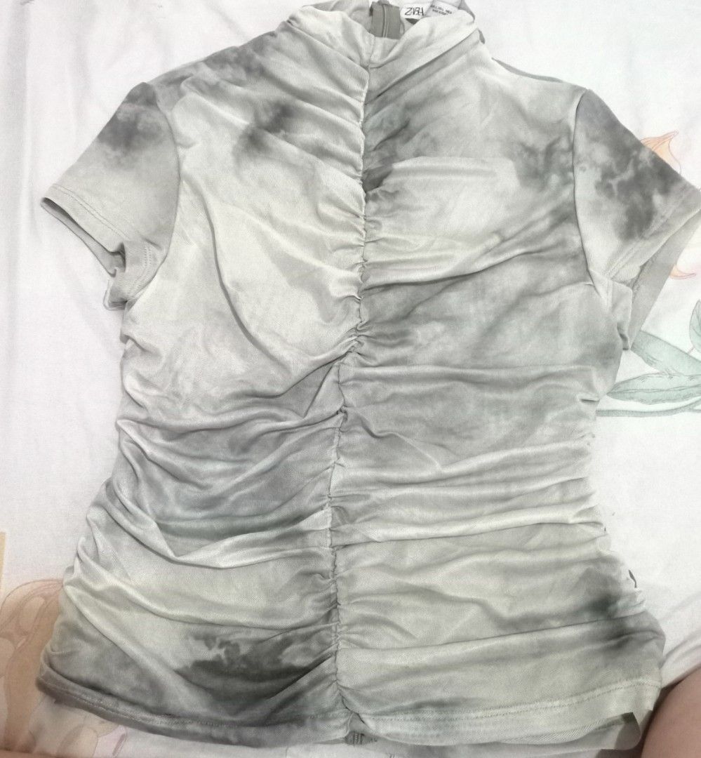 Zara Ruched Tie-Dye Mesh Top (Category: Sleeveless) located in Makati City. Submitted by gonzalesde66090 (Listing ID 1467967830, Image 1). Description: - Brand: Zara - Size: L (Made in Portugal) - Color/Print: Green and grey tie-dye - Material: Stretchy mesh fabric - Features: Mock neck, short sleeves, ruched front and back seams, back zipper closure - Condition: Worn once, basically good as new.