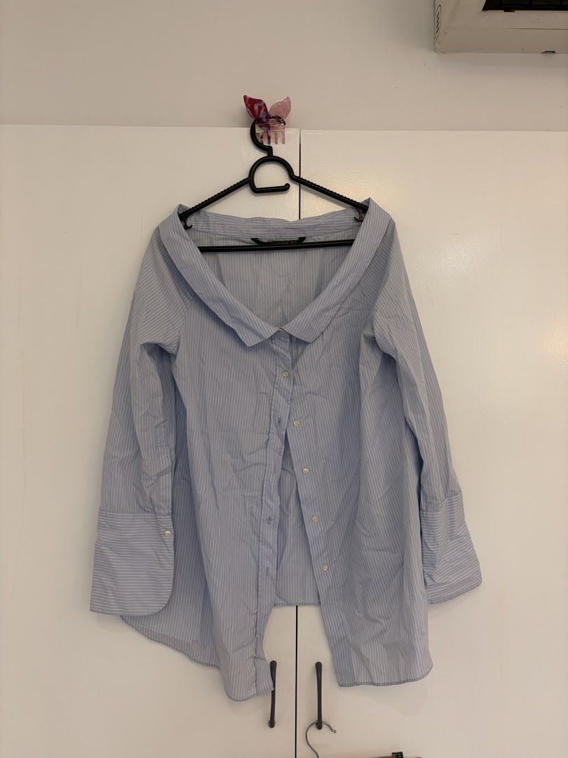 Zara Striped Off Shoulder Button Down (Category: Blouses) located in Quezon City. Submitted by prelovedbynxkole (Listing ID 1467884838, Image 1). Description: - Brand: Zara Trafaluc Collection - Design: Light blue and white vertical stripes - Fit: Oversized with trendy off-the-shoulder foldover collar - Details: Long sleeves with wide buttoned cuffs - Size: M - Origin: Made in Morocco - Style: Versatile; easy to dress up or wear casually ALL CLOT