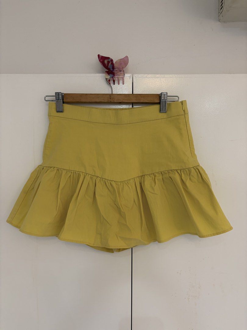 Zara Yellow Ruffle Mini Skort (Category: Skirts) located in Quezon City. Submitted by prelovedbynxkole (Listing ID 1467880445, Image 1). Description: - Brand: Zara - Color: Bright yellow - Size: Medium (true to size) - Style: Dropped waist with flared ruffle hem, with built-in shorts - Closure: Side zip - Condition: Clean, worn a couple of times only ALL CLOTHES NEED TO BE WASHED & IRONED AS THEY HAVE BEEN SITTING IN STORAGE <3 Shipping from QC! 
