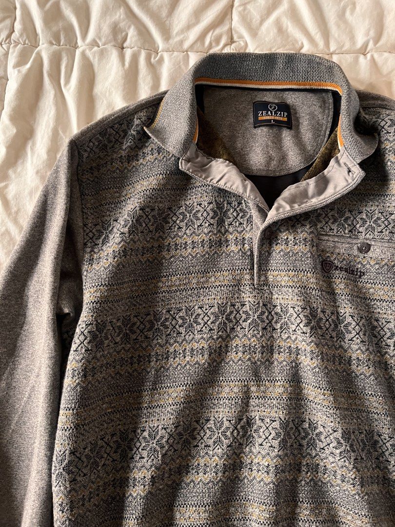 Zealzip Grey Patterned Quarter Button Sweater Size L (Category: Coats, Jackets and Outerwear) located in Manila. Submitted by miyu.ga (Listing ID 1467919717, Image 2). Description: - Brand: Zealzip - Color: Grey with intricate Nordic knit pattern - Size: Large - Details: Quarter button closure, foldover collar, subtle orange piping on inner collar - Fit: Ribbed cuffs and hem for a snug fit - Condition: Great cold weather staple.